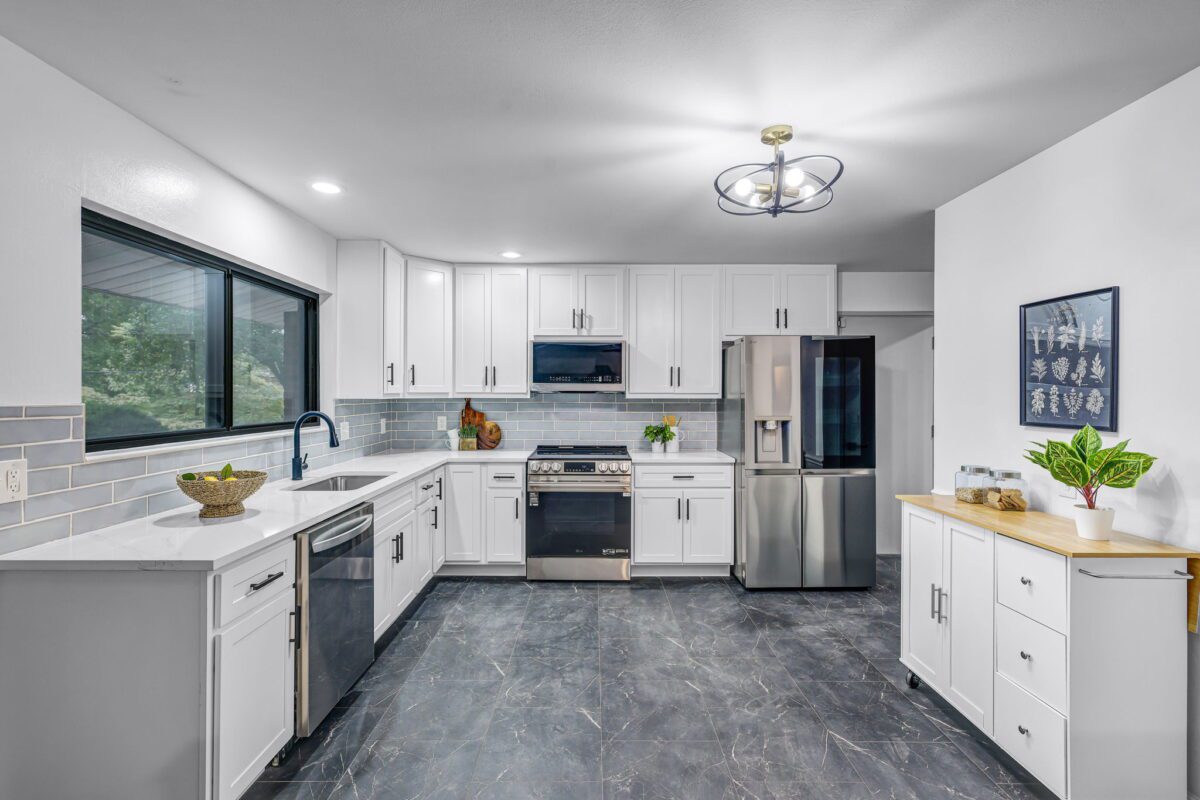 Bright L-shaped kitchen with gray tile floor